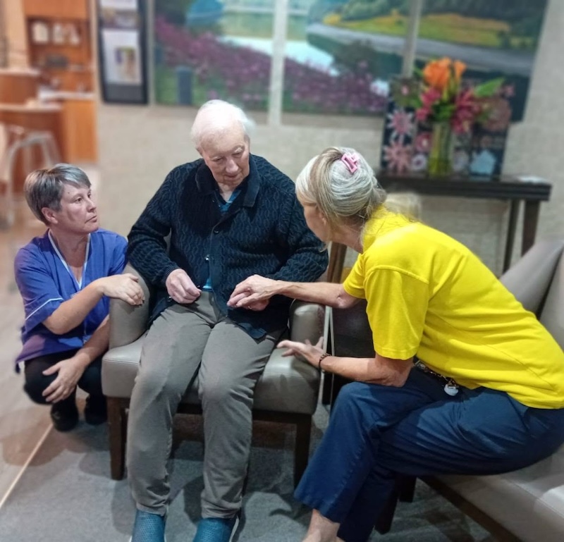 one of our resident sat with 2 carers in the lounge