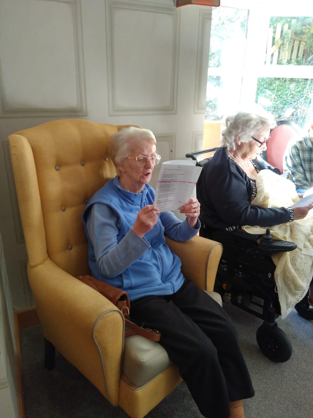 Our residents reading a Christmas service at our festive celebrations at The Porterbrook Care Home