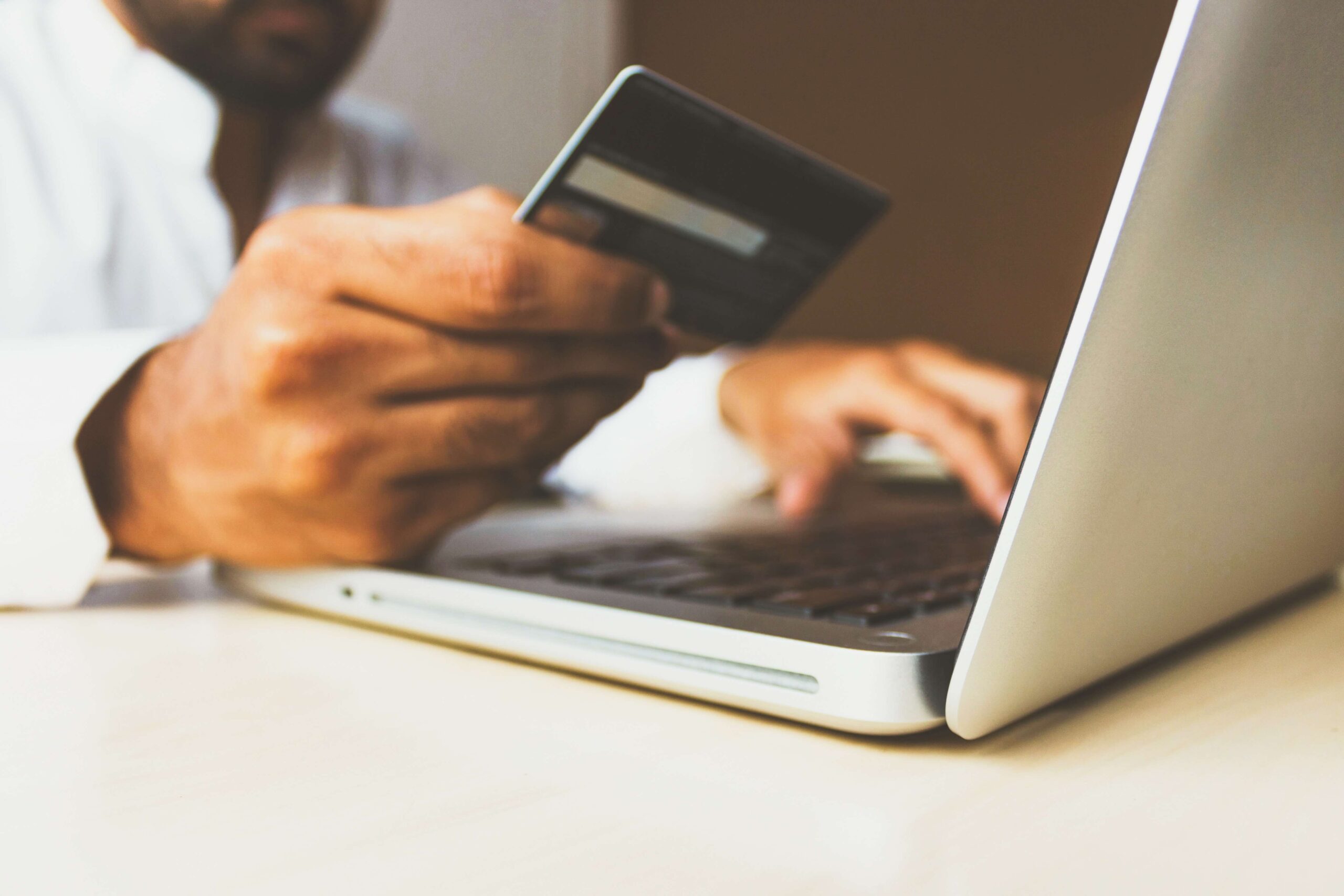 A person uses a debit card to make an online purchase