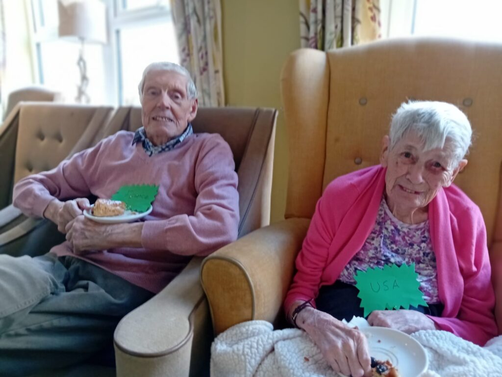 a resident couple sat in chairs enjoying their breakfast