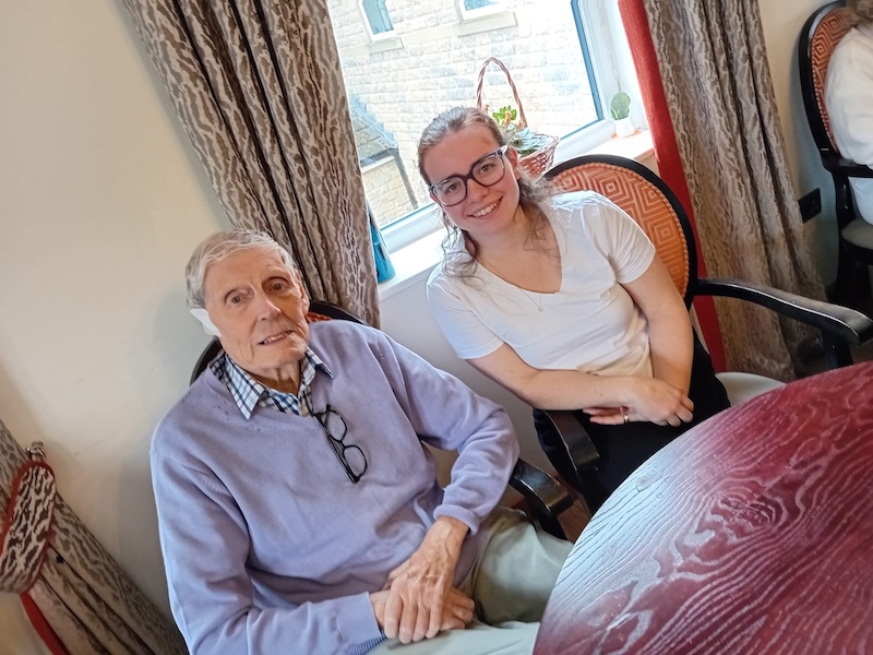 resident and university student sat together chatting in our lounge