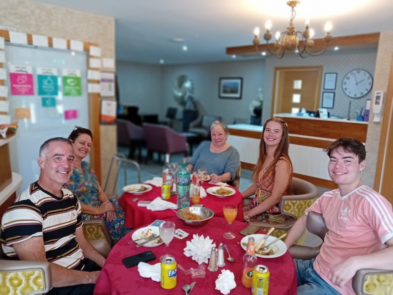 a group family photo sat in our bar area with a thai dinner