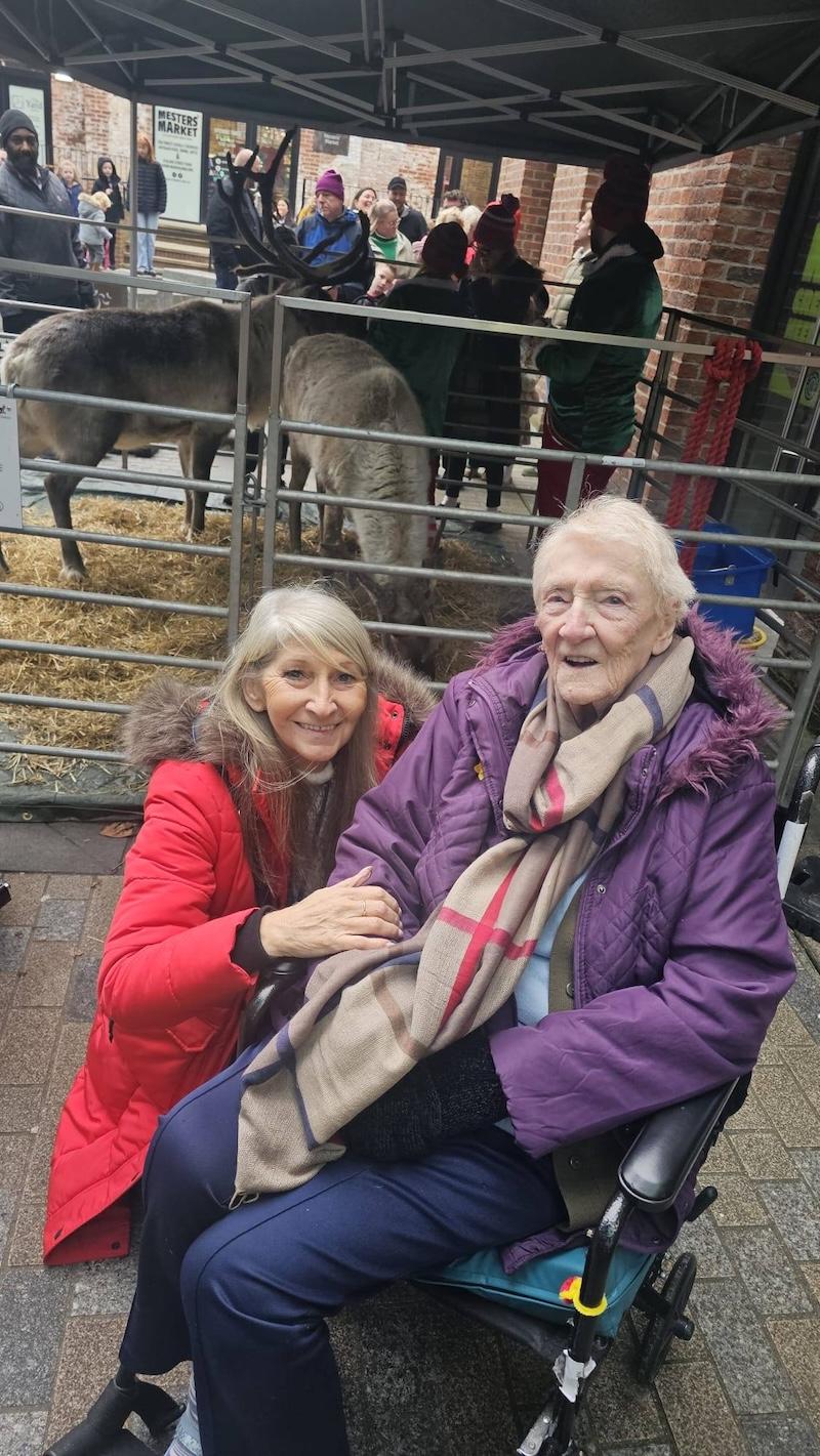 resident and carer at a reindeer petting zoo