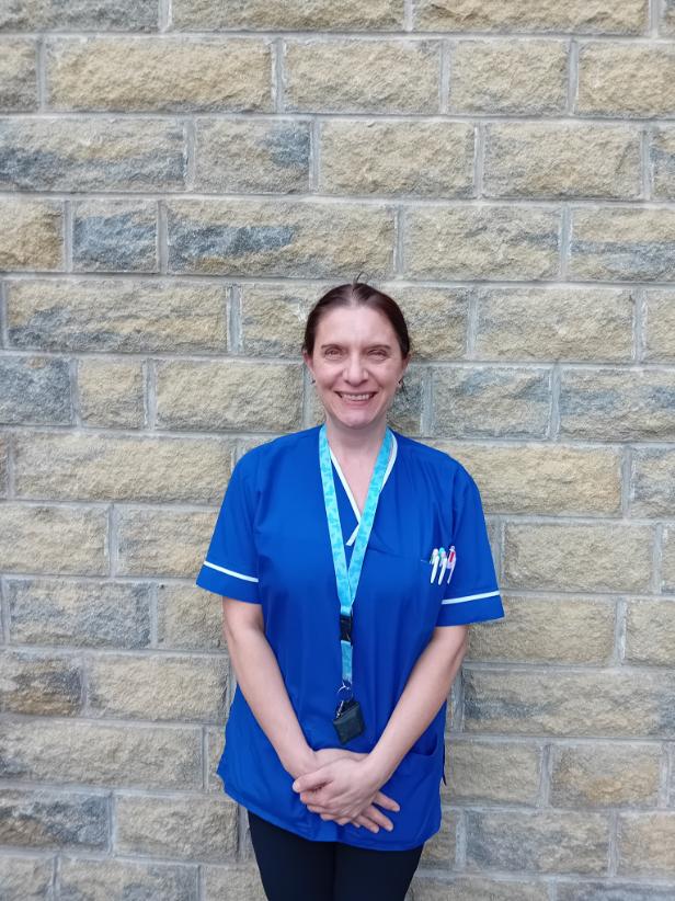 woman in nurse uniform smiling at camera