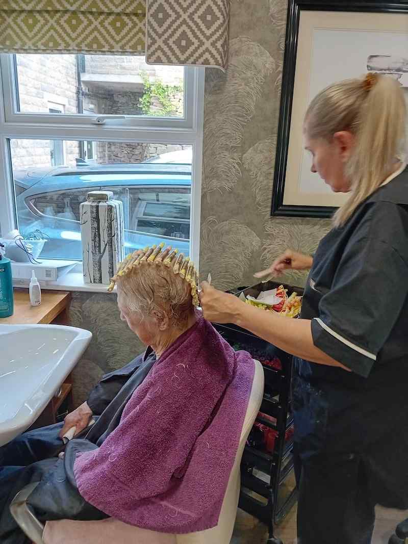 resident having their hair done in our salon