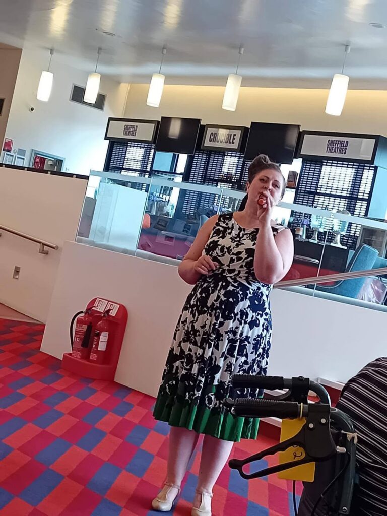 a lady holding a microphone singing