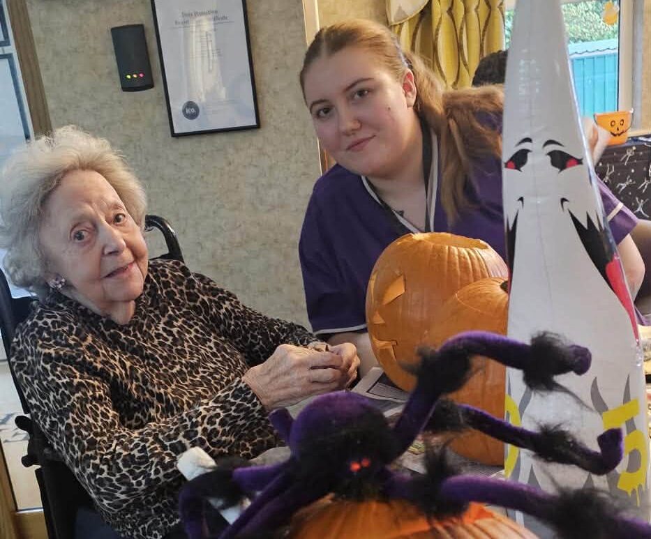 older lady and a carer with halloween decorations